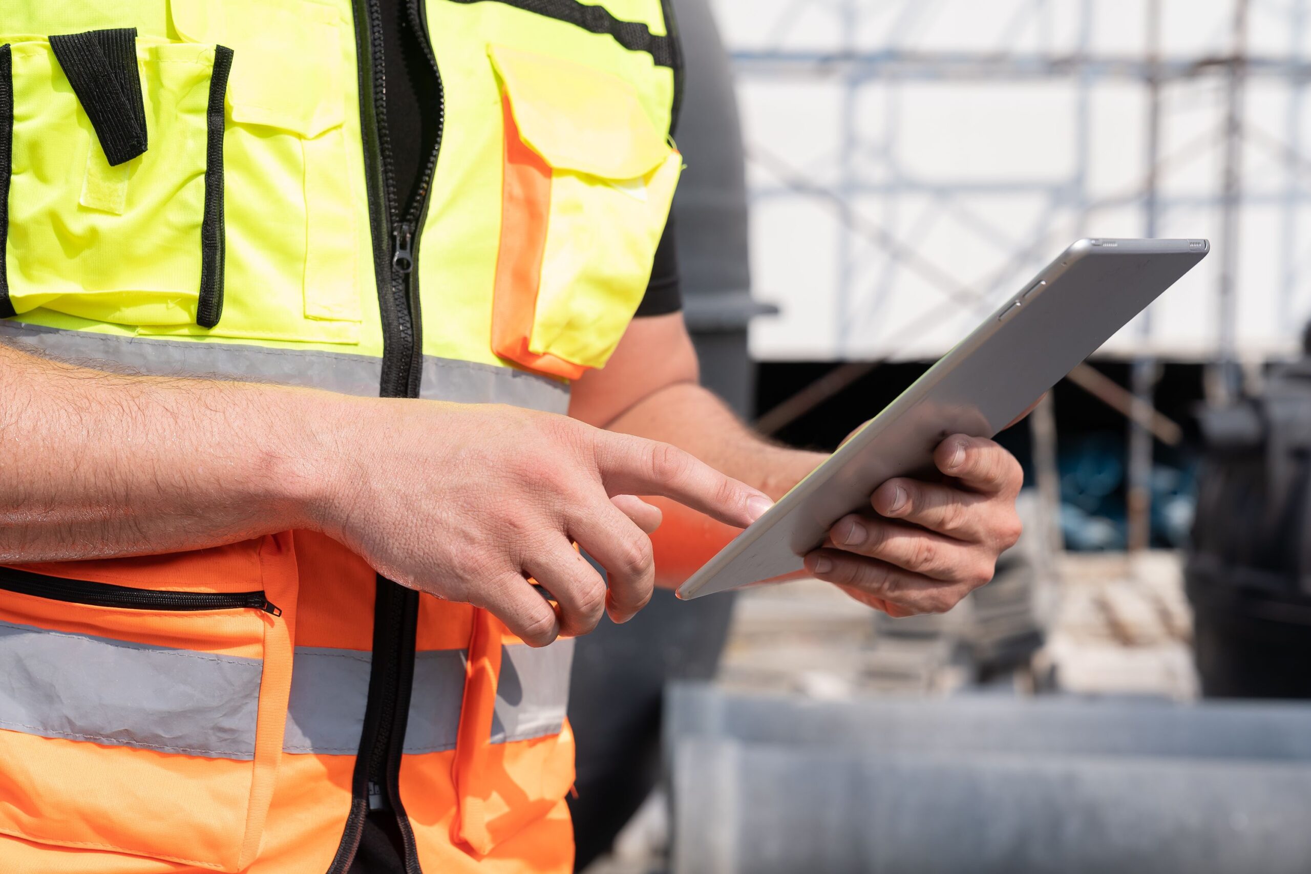 Pracownik firmy relokacyjnej sprawdza na tablecie dokumentację techniczną maszyn produkcyjnych